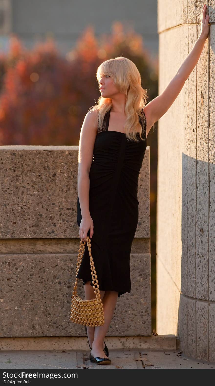 Woman Leaning Against Wall Outside