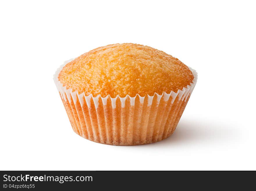 Cupcake in paper bakeware. Closeup. Laying on a white.