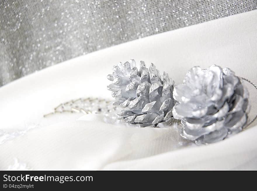 Close up silver pine cones on white background