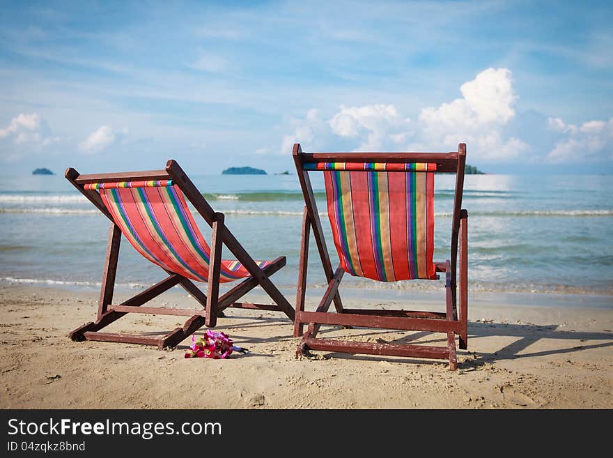 Two Bright Sun Loungers On The Beach.