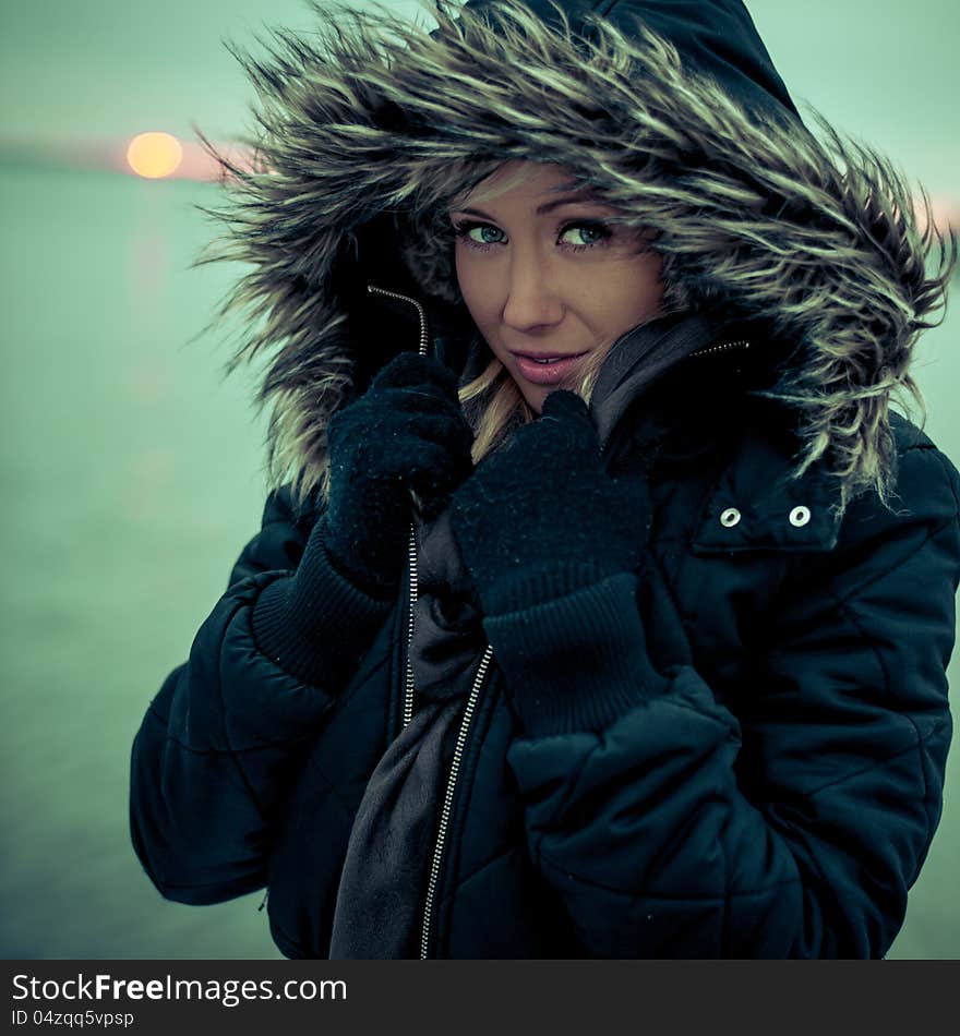 Blond girl outside in the sunset on a winter day. Blond girl outside in the sunset on a winter day