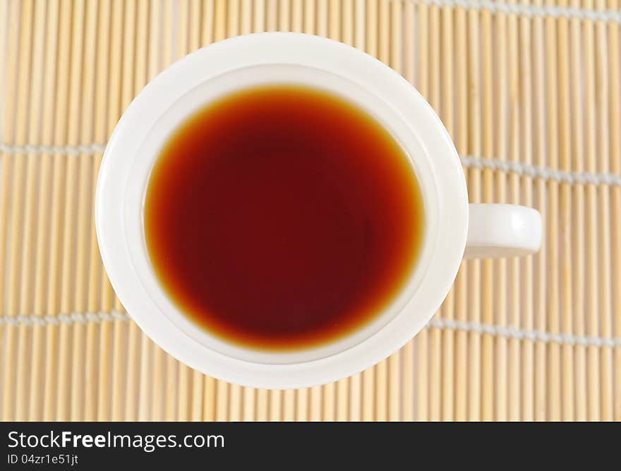 A cup of black tea on the white background