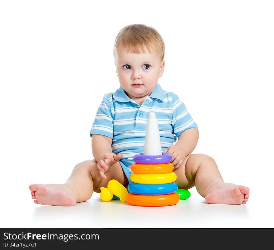 Funny baby boy playing with colorful toy on white