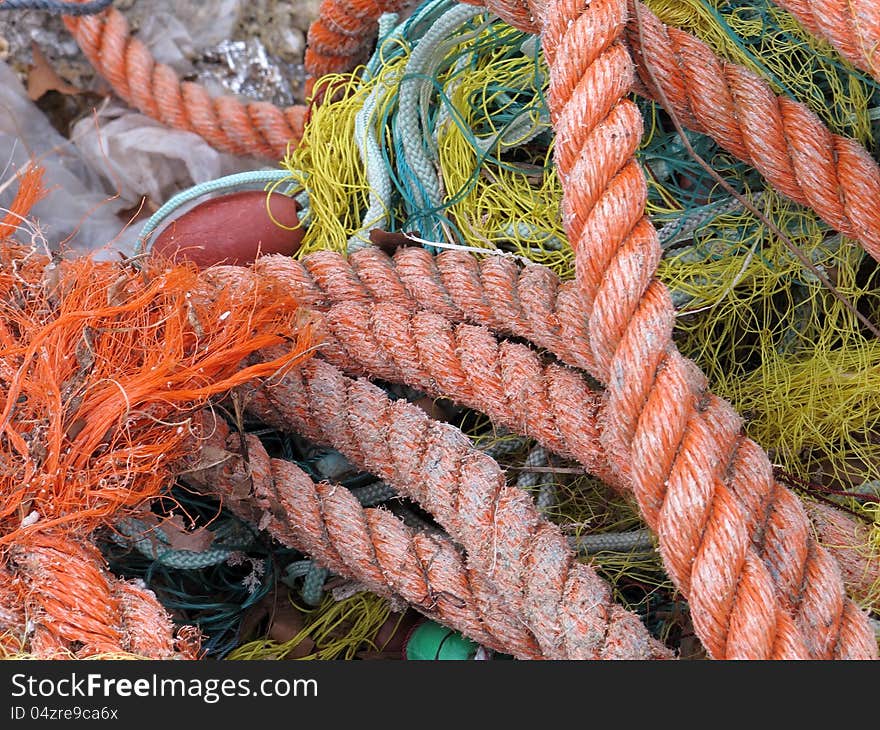 Tangled fishing nets and ropes dry in the sun