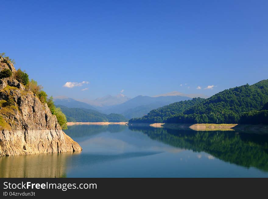 Lake view with clear blue sky and green mountain forest. Lake view with clear blue sky and green mountain forest.