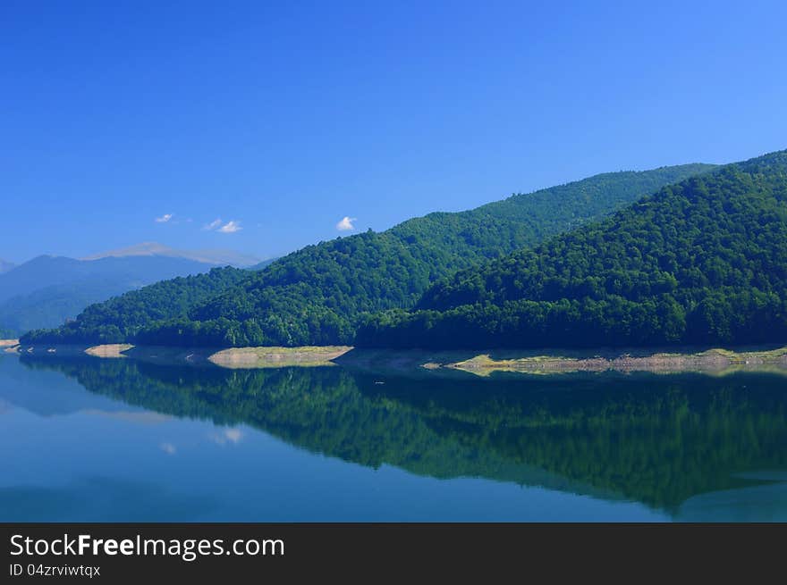 Beautiful mountain forest reflecting in the lake water. Beautiful mountain forest reflecting in the lake water.