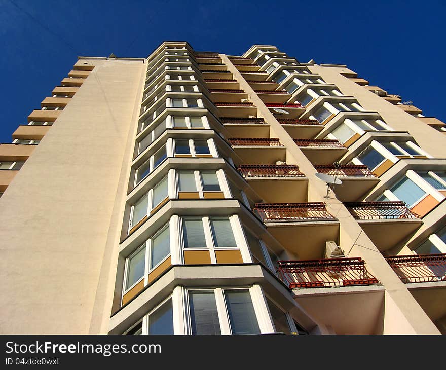 The multi-storey modern house on the blue sky background