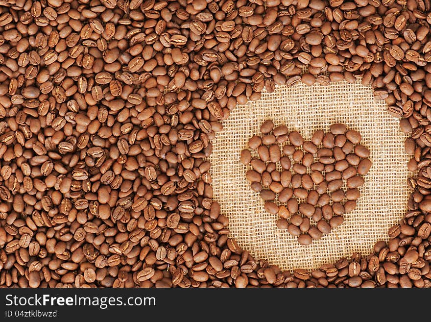 Heart coffee frame made of coffee beans on burlap texture