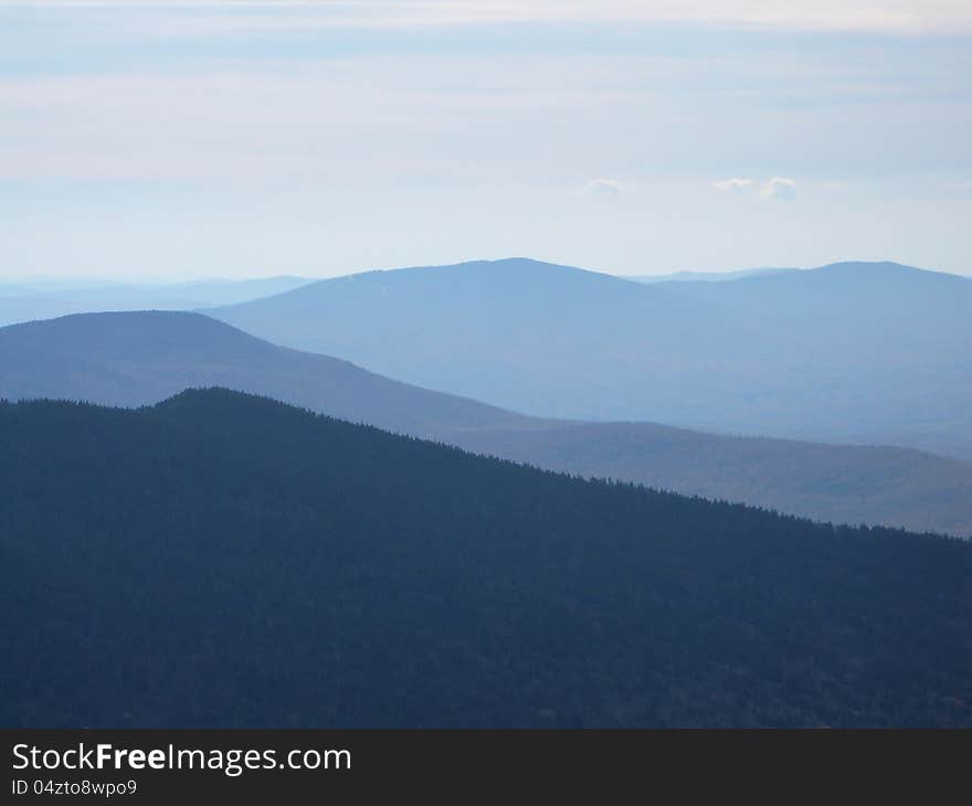 Mountain view from Killington peak with shades of blue mountains in the distance. Mountain view from Killington peak with shades of blue mountains in the distance.