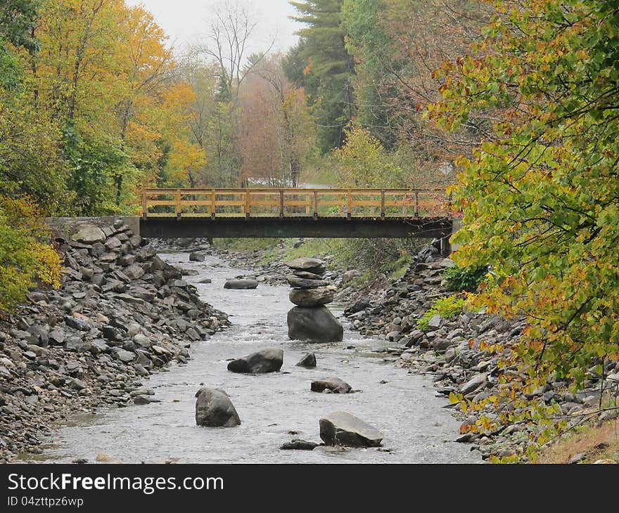 Ballanced rocks in river and bridge in Autumn on a rainy day. Ballanced rocks in river and bridge in Autumn on a rainy day.