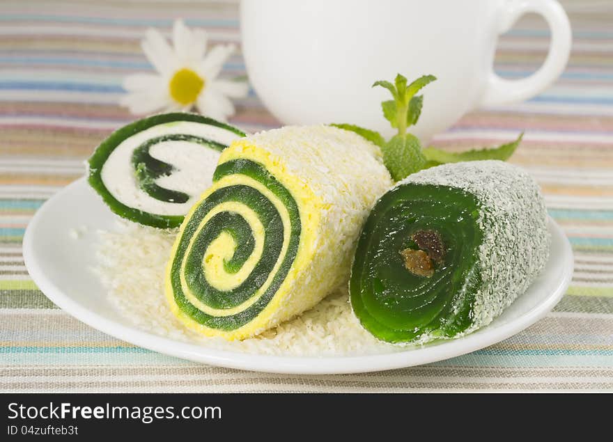 Sweet dessert in a plate with flower and cup, closeup