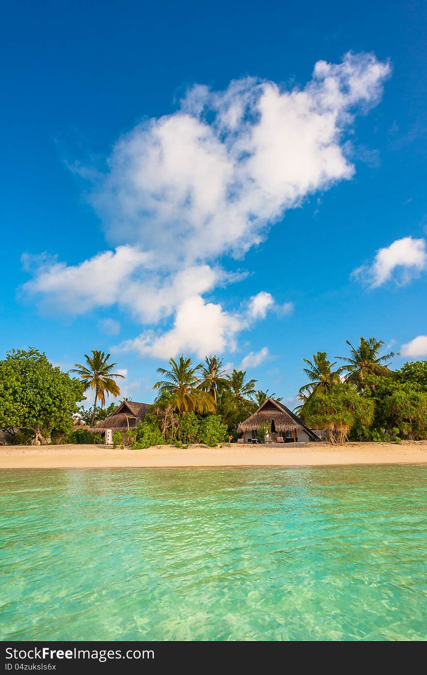 Tropical island beautiful landscape with emerald water, green trees and blue sky