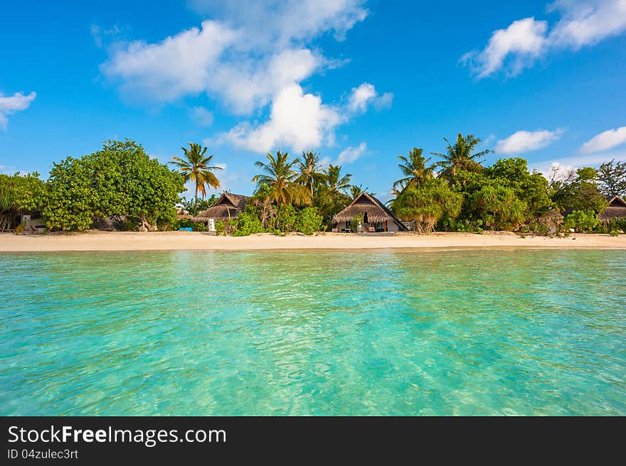 Tropical island beautiful landscape with emerald water, green trees and blue sky