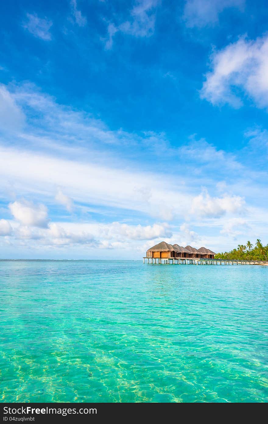 Tropical island beautiful landscape with emerald water, green trees and blue sky