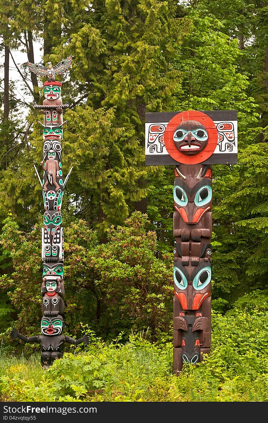 Pair of totem poles in Stanley Park, Vancouver, British Columbia. Pair of totem poles in Stanley Park, Vancouver, British Columbia