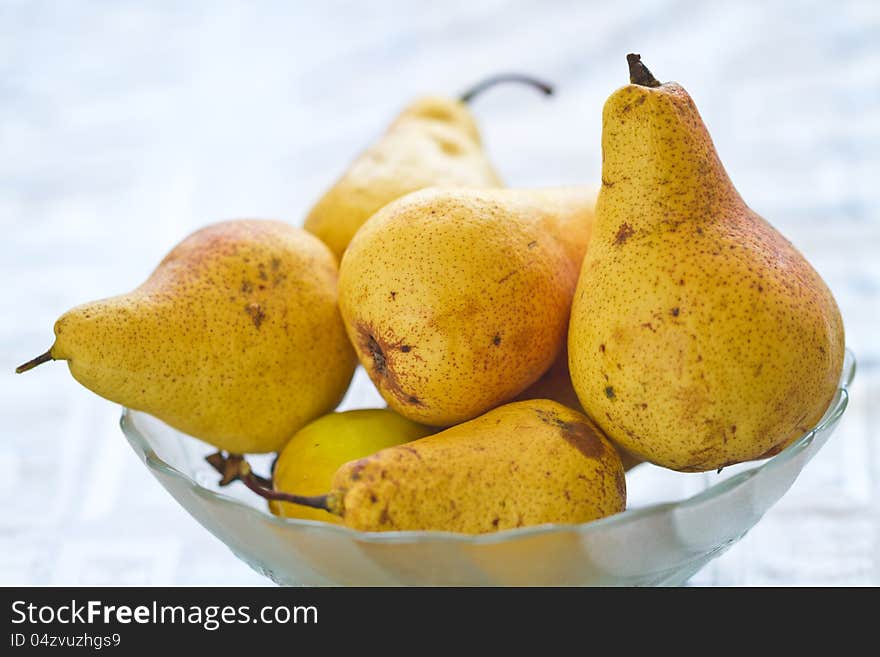 Fresh pears in glass cup