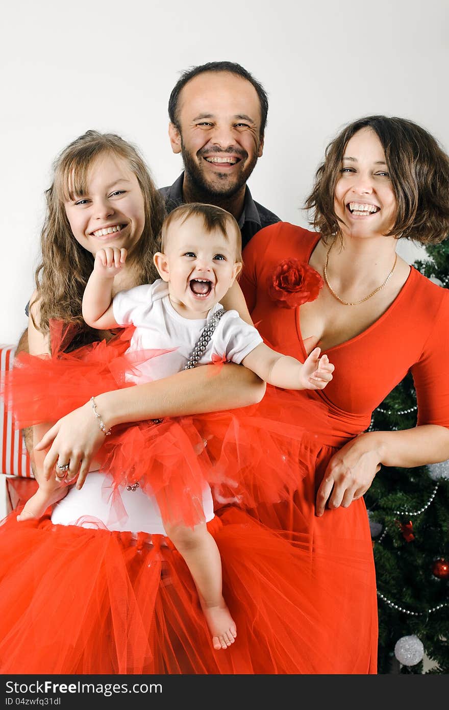 Happy Christmas family in a studio