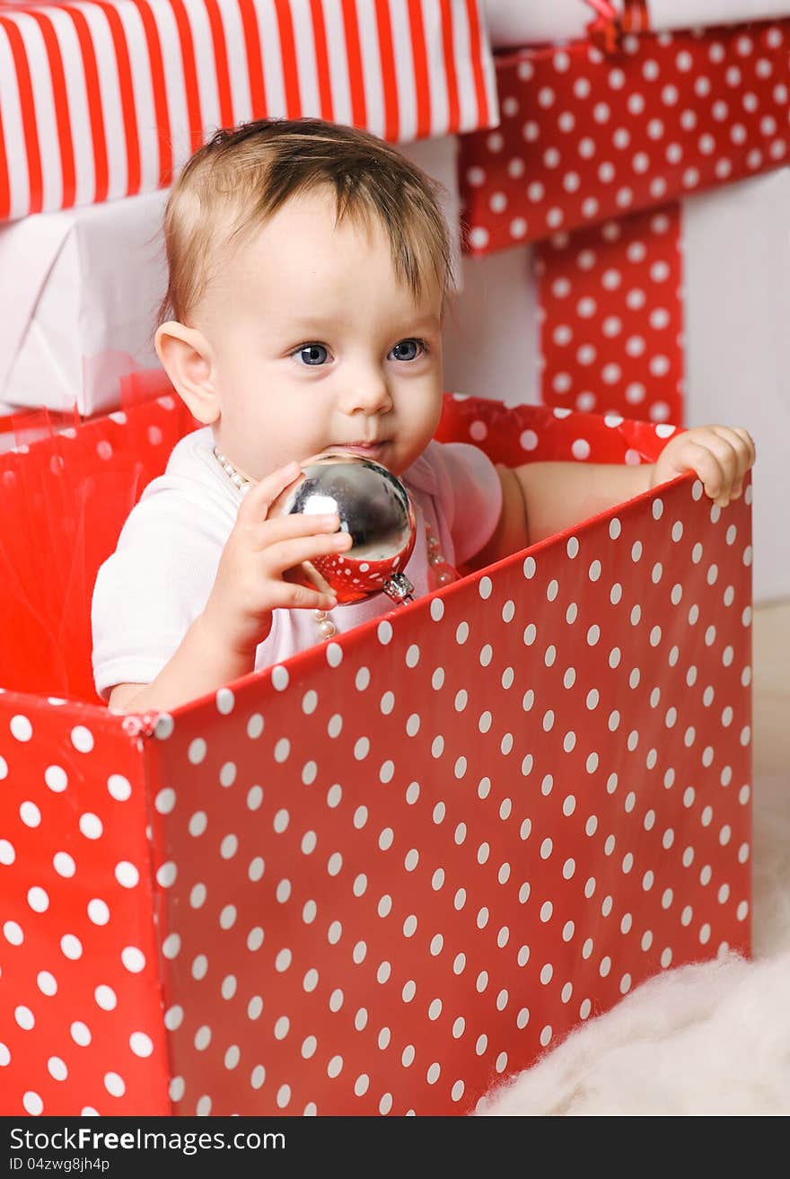 Christmas baby girl in a studio. Christmas time