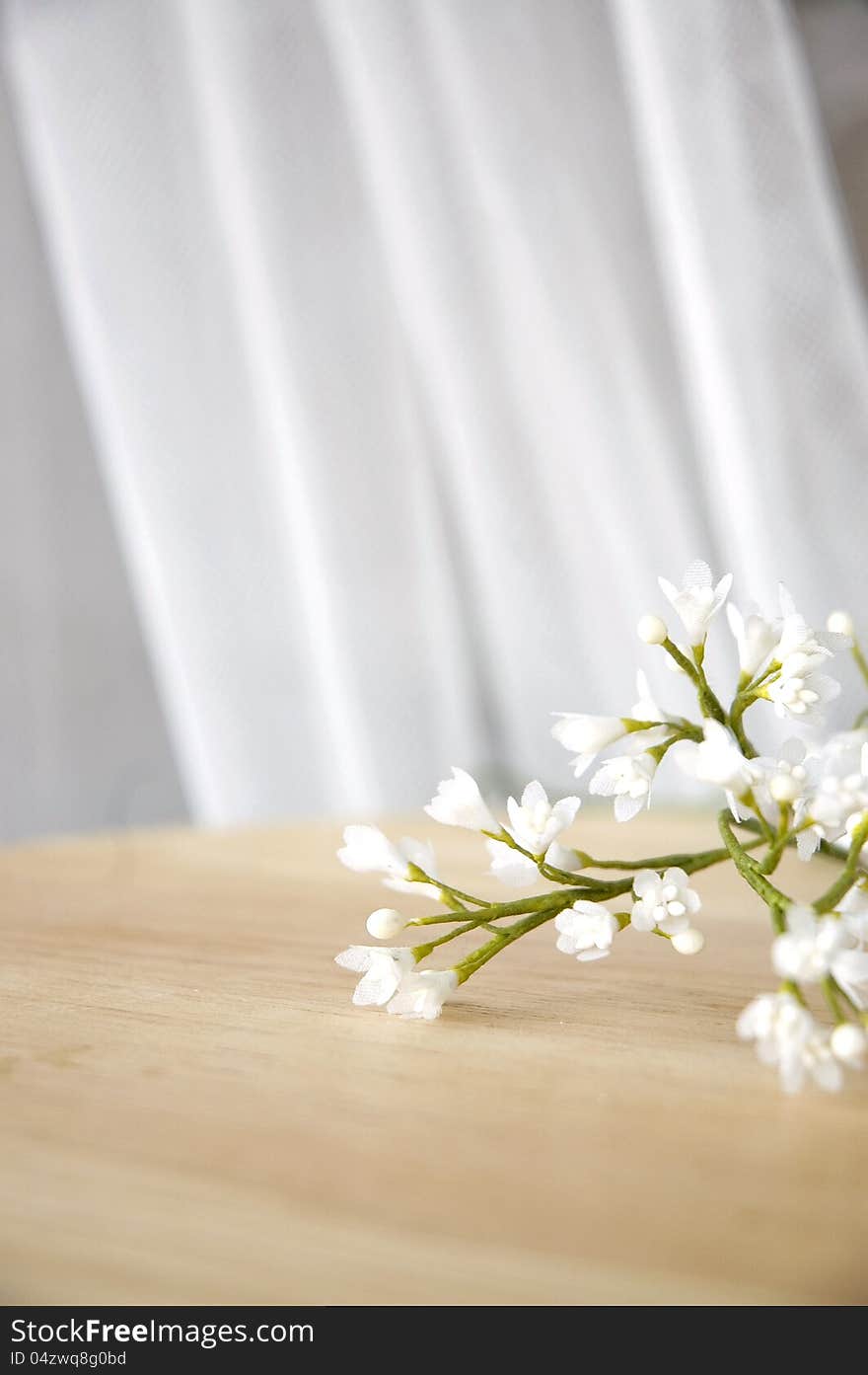 Pretty white artificial flowers on table