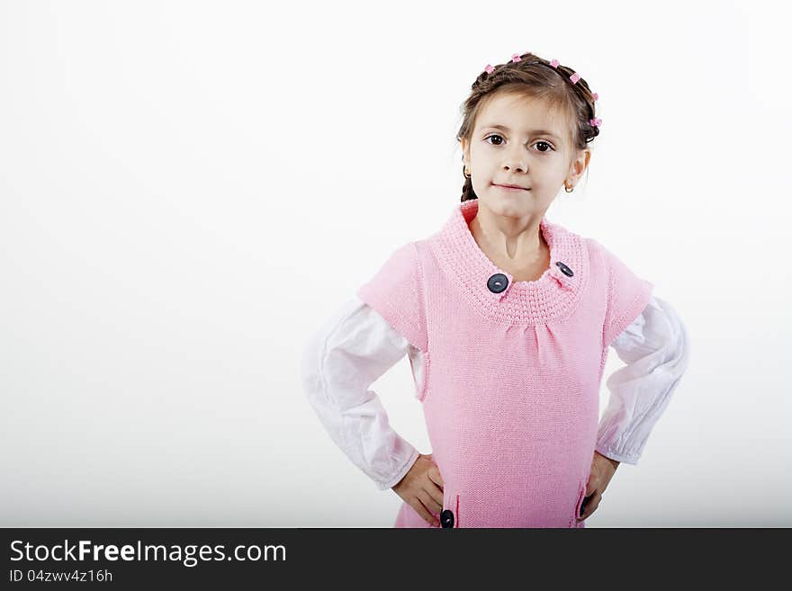 Beautiful white girl posing in studio with pink dress. Beautiful white girl posing in studio with pink dress