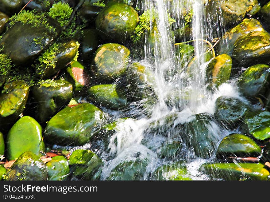 View of stone waterfall in botanical garden. View of stone waterfall in botanical garden