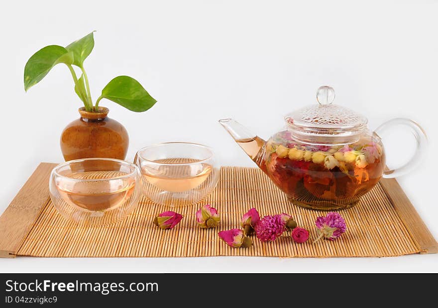 A pot of fresh flower tea on bamboo background