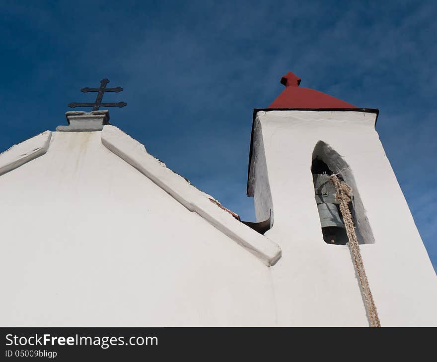 Front view of the church with cross and bell tower. Front view of the church with cross and bell tower