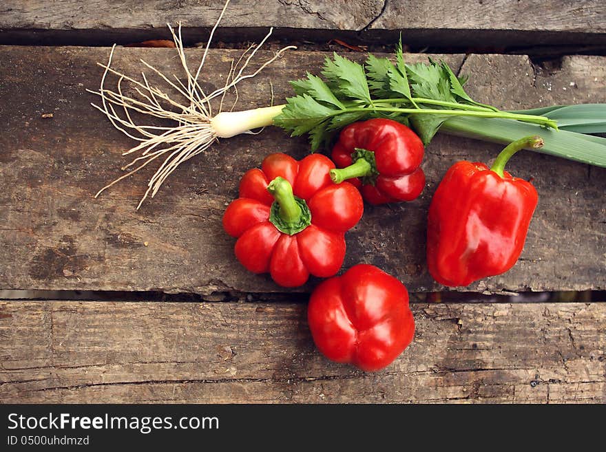 Red pepper and green onions on a table