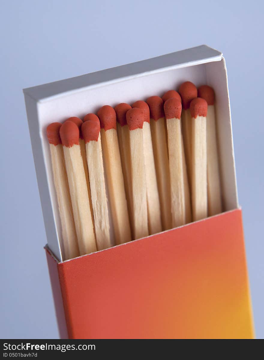 Matchbox with matches on gray