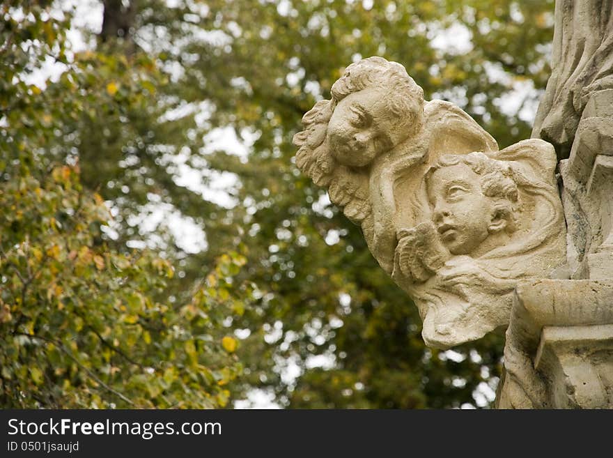 Two stone heads of children together