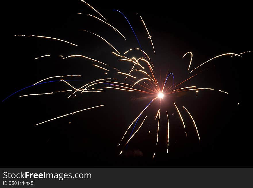 Red and blue fireworks on the black sky background