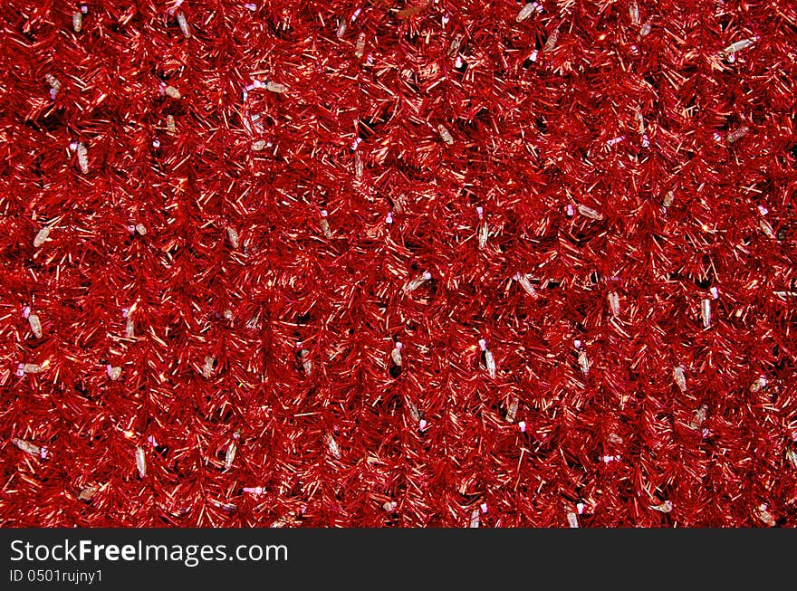 Red tinsel Christmas decoration background texture with white bulbs