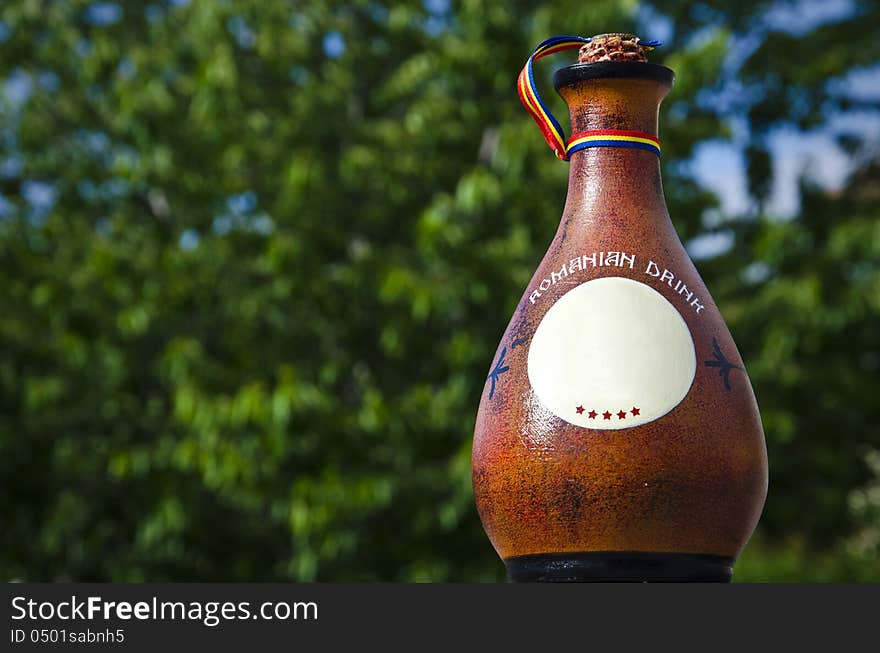 Traditional five stars romanian drink in a clay bottle. Traditional five stars romanian drink in a clay bottle