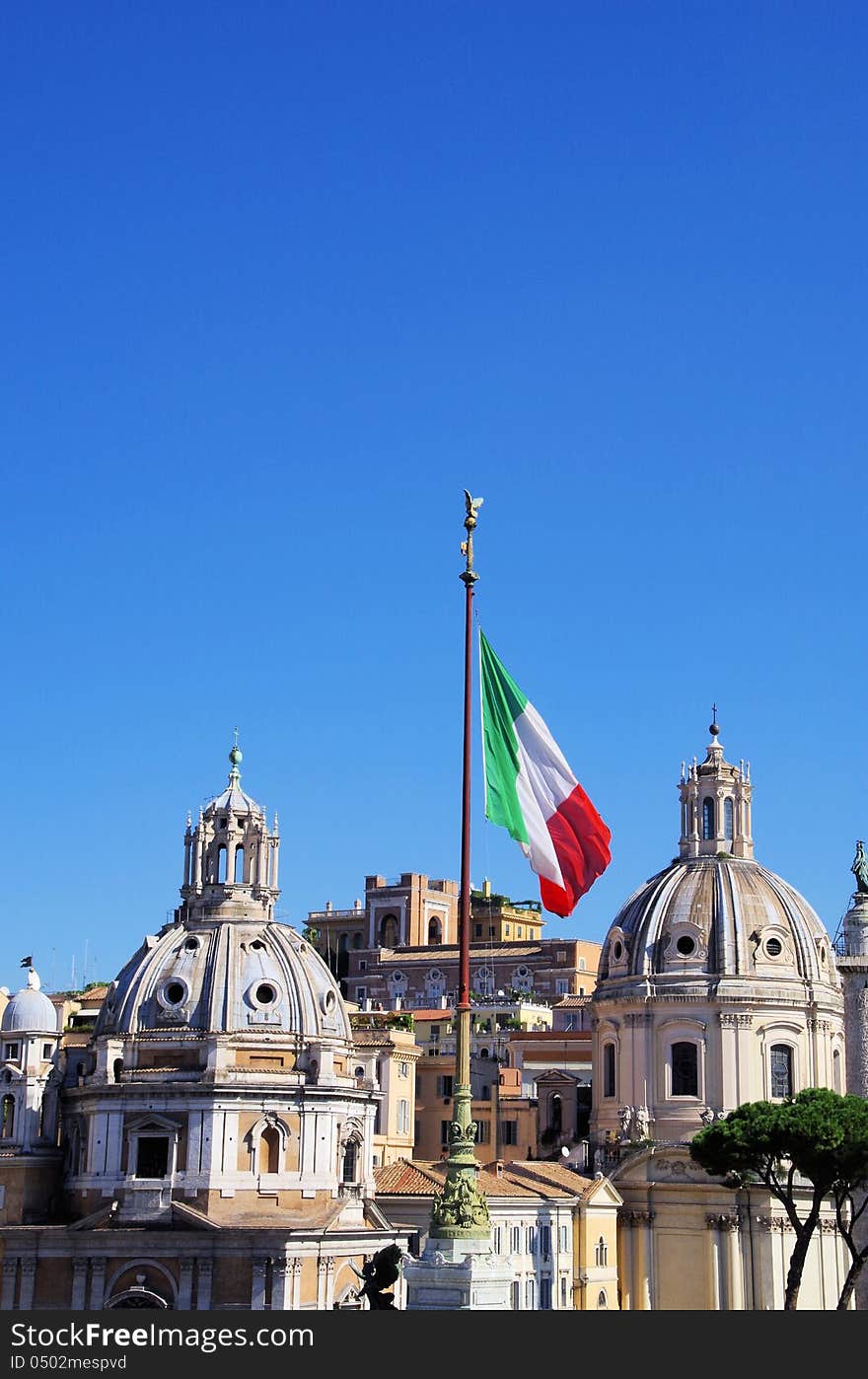 Beautiful Santa Maria di Loreto church and an Italian flag in Rom, Italy. Beautiful Santa Maria di Loreto church and an Italian flag in Rom, Italy