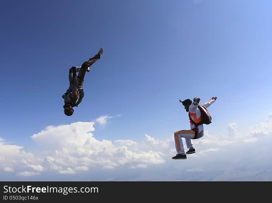 A group of paratroopers in a free style free fall. A group of paratroopers in a free style free fall.