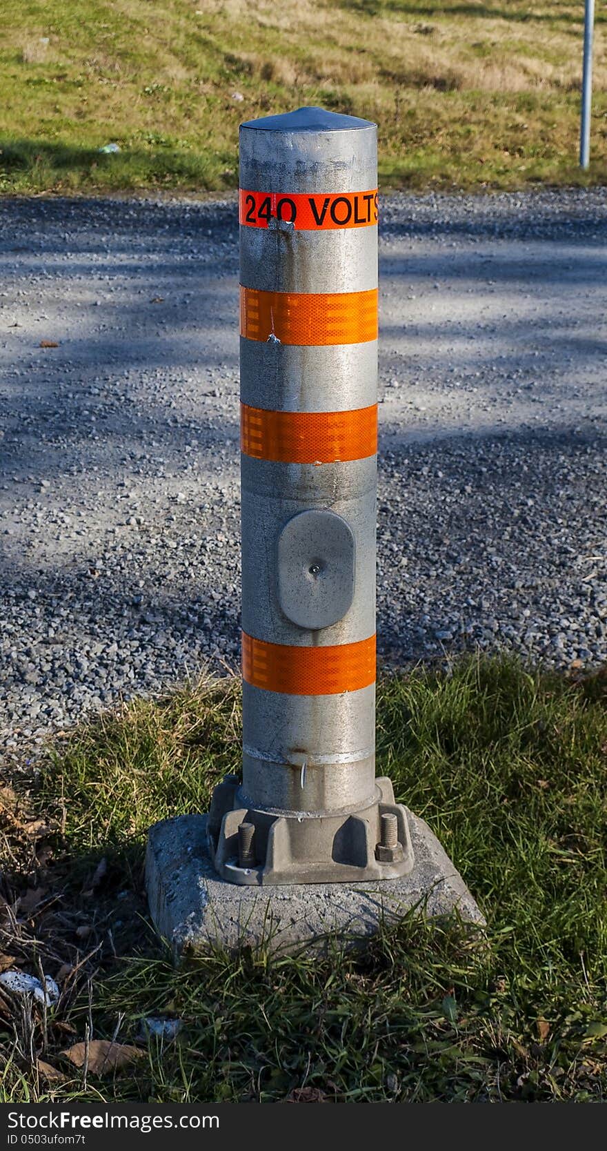 Electrical danger pole at the road entrance of a power plan