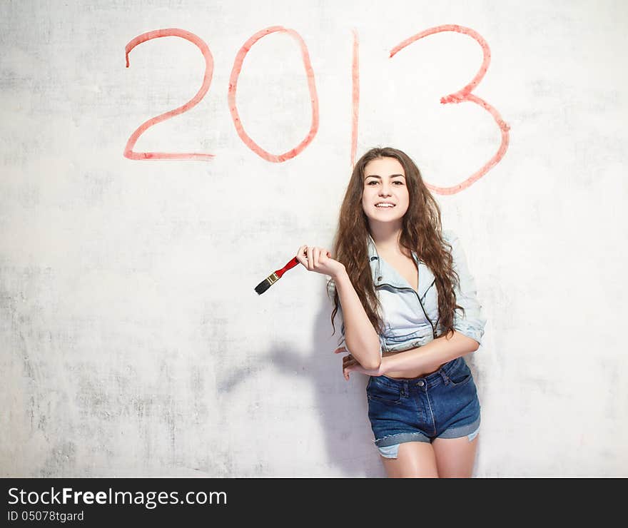 Girl Draws A Christmas Decoration On The Wall.