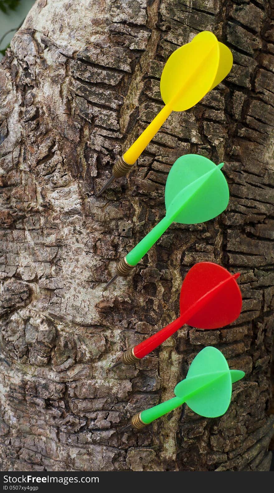 Four darts hitting in wood