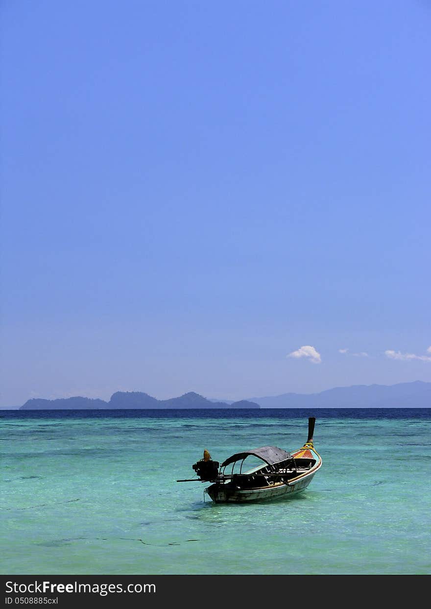 Long tail boat with beautiful sky , clear water at the Lipe Island Thailand