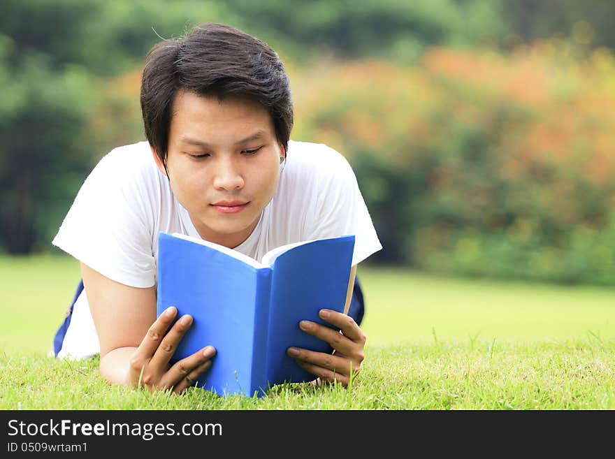 Young man reading a book in outdoor