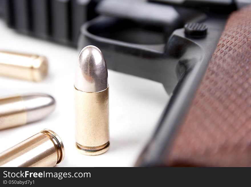 9mm bullets and semi-automatic pistol closeup, shallow dof. 9mm bullets and semi-automatic pistol closeup, shallow dof