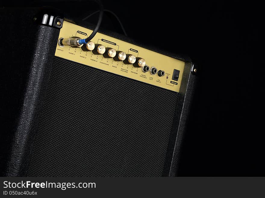 A small guitar amplifier on black background