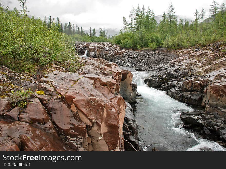 Roaring waterfalls on the river dug canyon