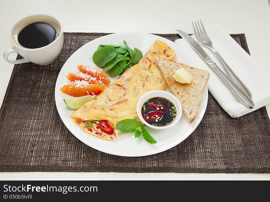 Healthy omelette with chillies, coriander, paw paw, spinach lime and spicy soy sauce. Healthy omelette with chillies, coriander, paw paw, spinach lime and spicy soy sauce