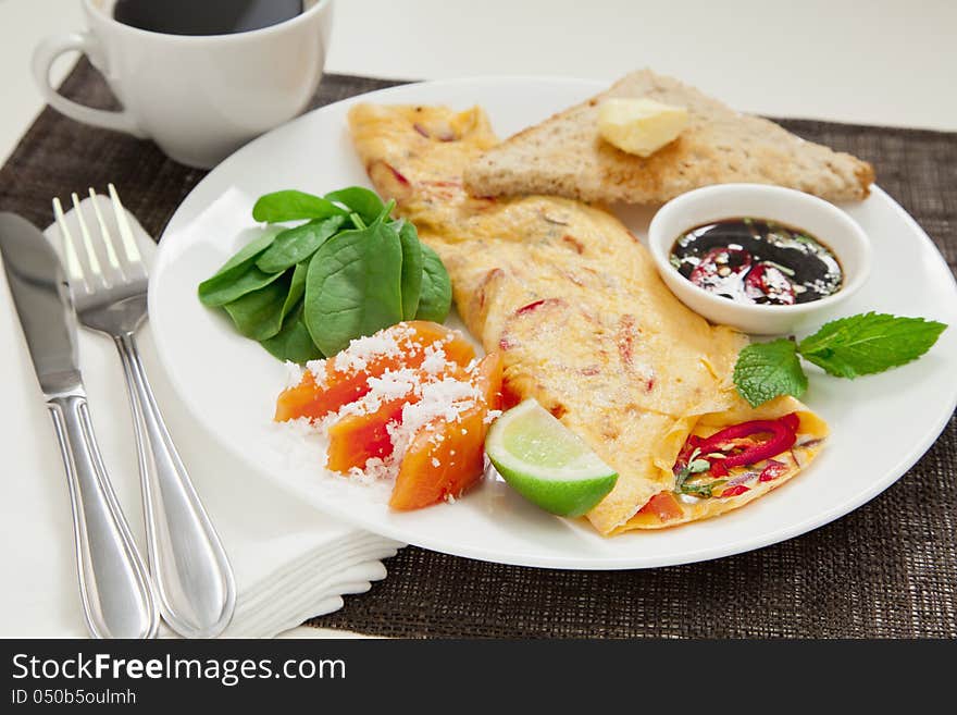 Healthy omelette with chillies, coriander, paw paw, spinach lime and spicy soy sauce. Healthy omelette with chillies, coriander, paw paw, spinach lime and spicy soy sauce