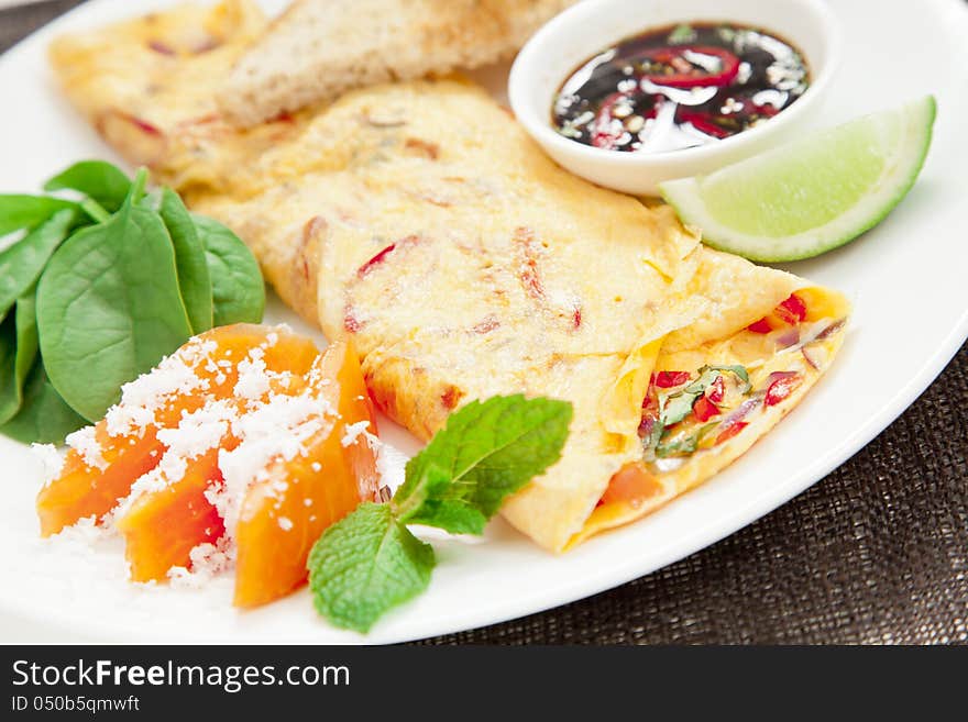 Healthy omelette with chillies, coriander, paw paw, spinach lime and spicy soy sauce. Healthy omelette with chillies, coriander, paw paw, spinach lime and spicy soy sauce