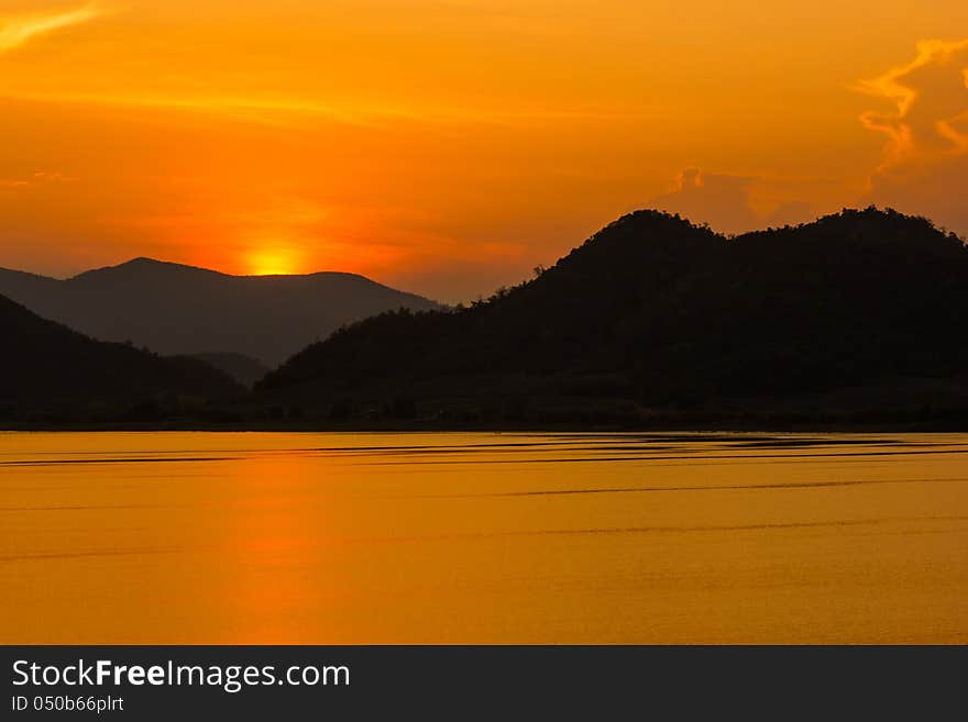 Colorful sunset over the water at dam. Colorful sunset over the water at dam