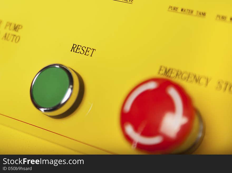 Green reset button and red emergency stop switch. Green reset button and red emergency stop switch