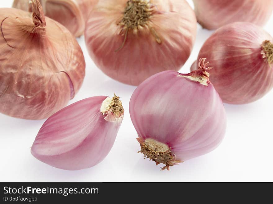 Group of small red shallot on white background