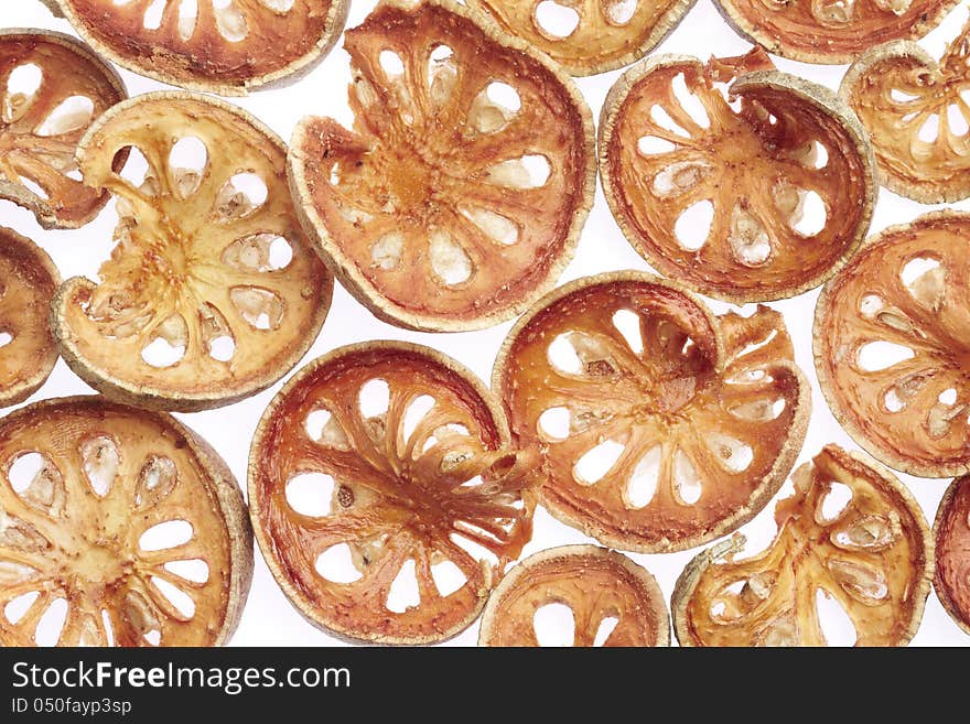 Slices of dried bael fruit on white background